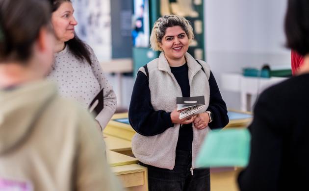 Een vrouw luistert aandachtig naar de gids